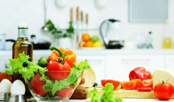 Healthy fruits and vegetables on a kitchen table