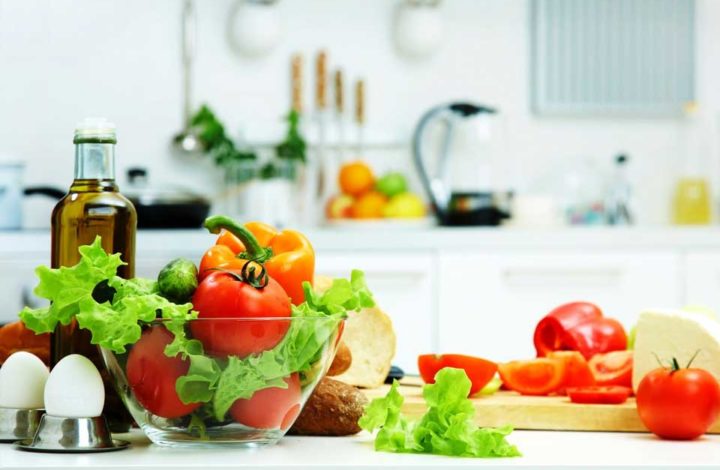 Healthy fruits and vegetables on a kitchen table