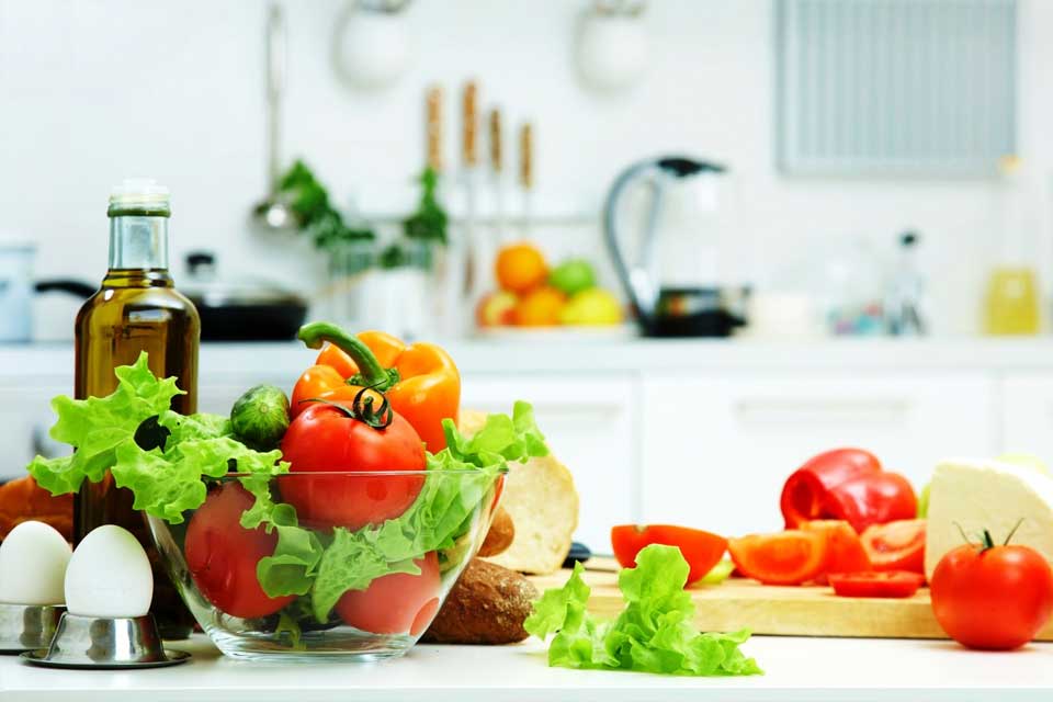 Healthy fruits and vegetables on a kitchen table